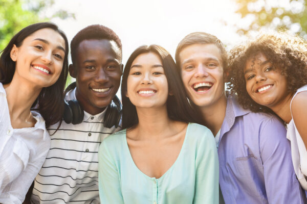 Portrait,Of,Cheerful,Interracial,Teen,Friends,Posing,At,Camera,Outdoors,
